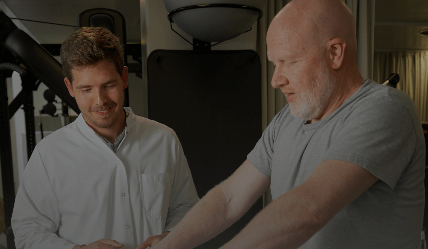 Medical professional assisting an older man during a clinical study session
